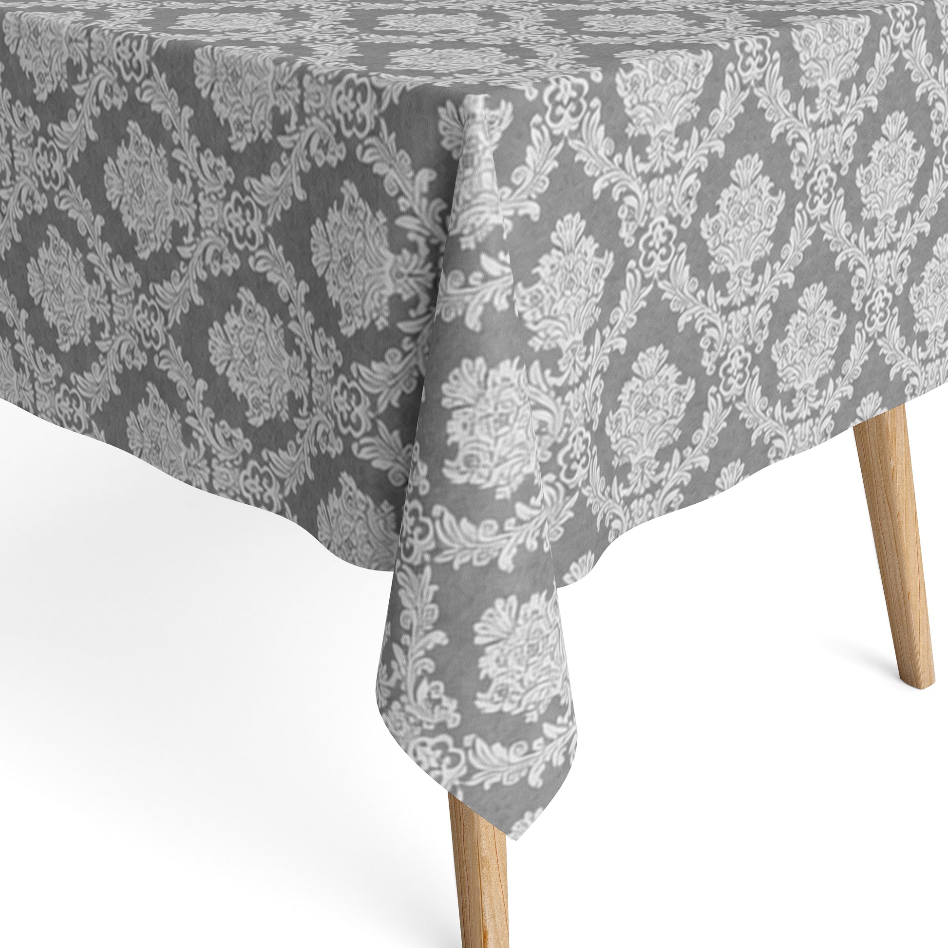 Detailaufnahme einer anthrazitfarbenen Jacquard-Tischdecke mit klassischem Ornamentmuster, beschichteter Baumwolle und Fleckenschutz.
