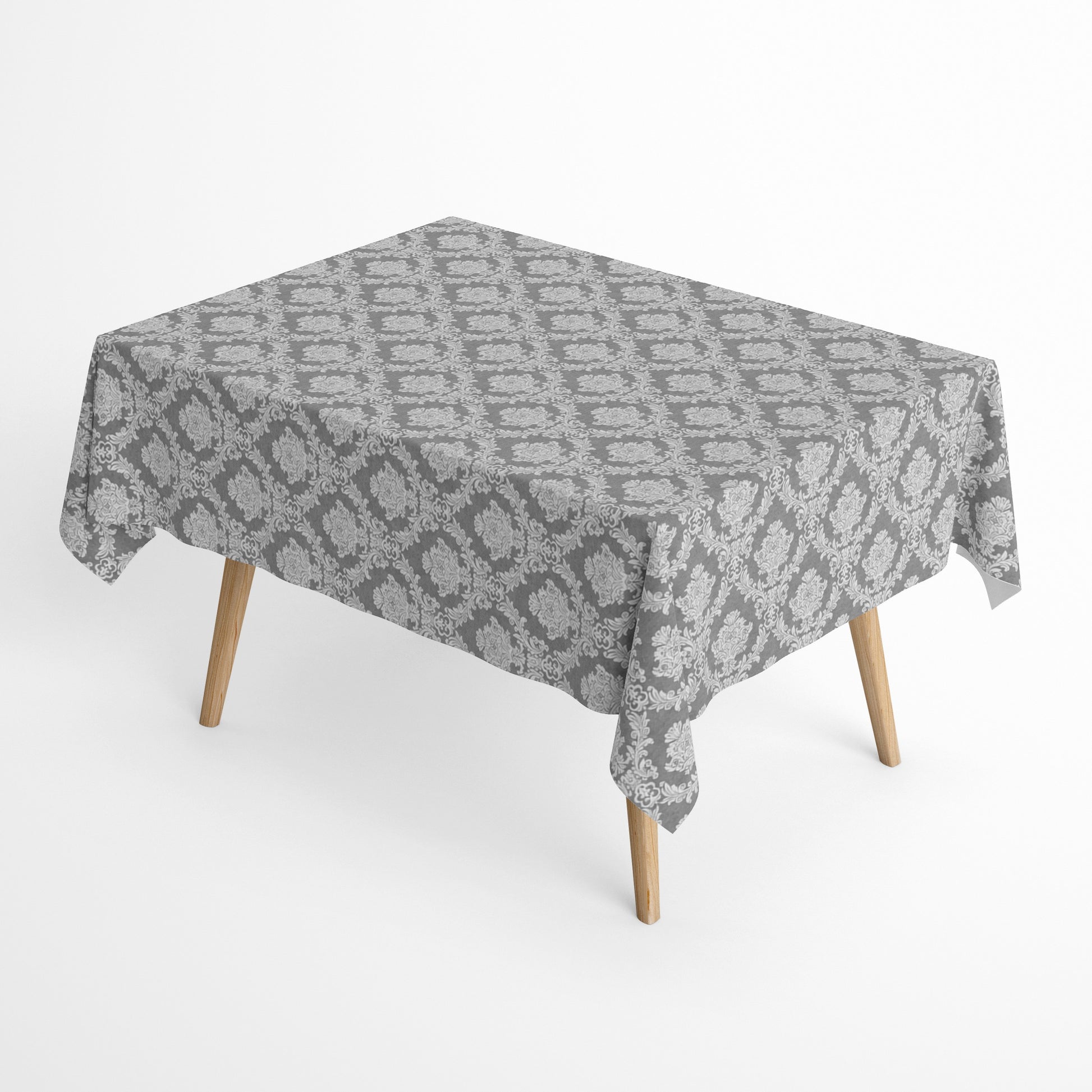 Detailaufnahme einer anthrazitfarbenen Jacquard-Tischdecke mit klassischem Ornamentmuster, beschichteter Baumwolle und Fleckenschutz.