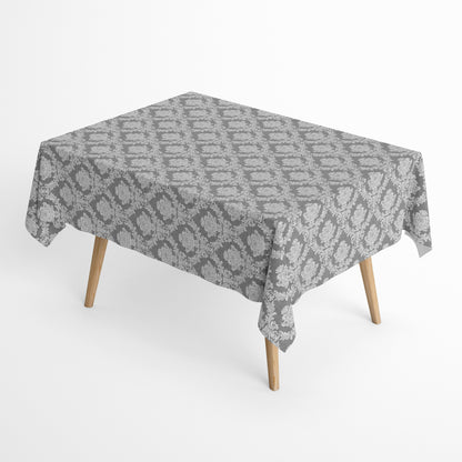 Detailaufnahme einer anthrazitfarbenen Jacquard-Tischdecke mit klassischem Ornamentmuster, beschichteter Baumwolle und Fleckenschutz.