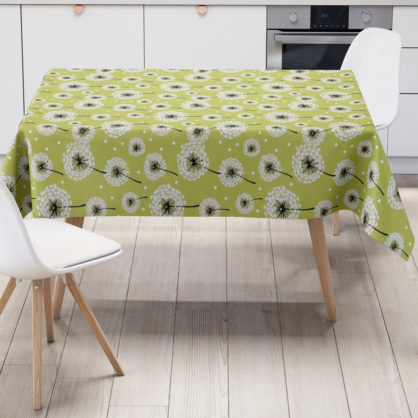 Wachstuch-Tischdecke mit weißen Pusteblumen in verschiedenen Größen auf hellgrünem Hintergrund. Schwarze Stiele und kleine weiße Punkte ergänzen das verspielte, natürliche Design mit leichter, frischer Ausstrahlung.