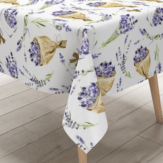 Wachstuch-Tischdecke mit Lavendelmuster auf hellem Hintergrund. Violette Lavendelzweige, kleine Sträuße und in Papier gewickelte Lavendelbouquets sind gleichmäßig verteilt und werden durch grüne Stiele sowie braune Details ergänzt.