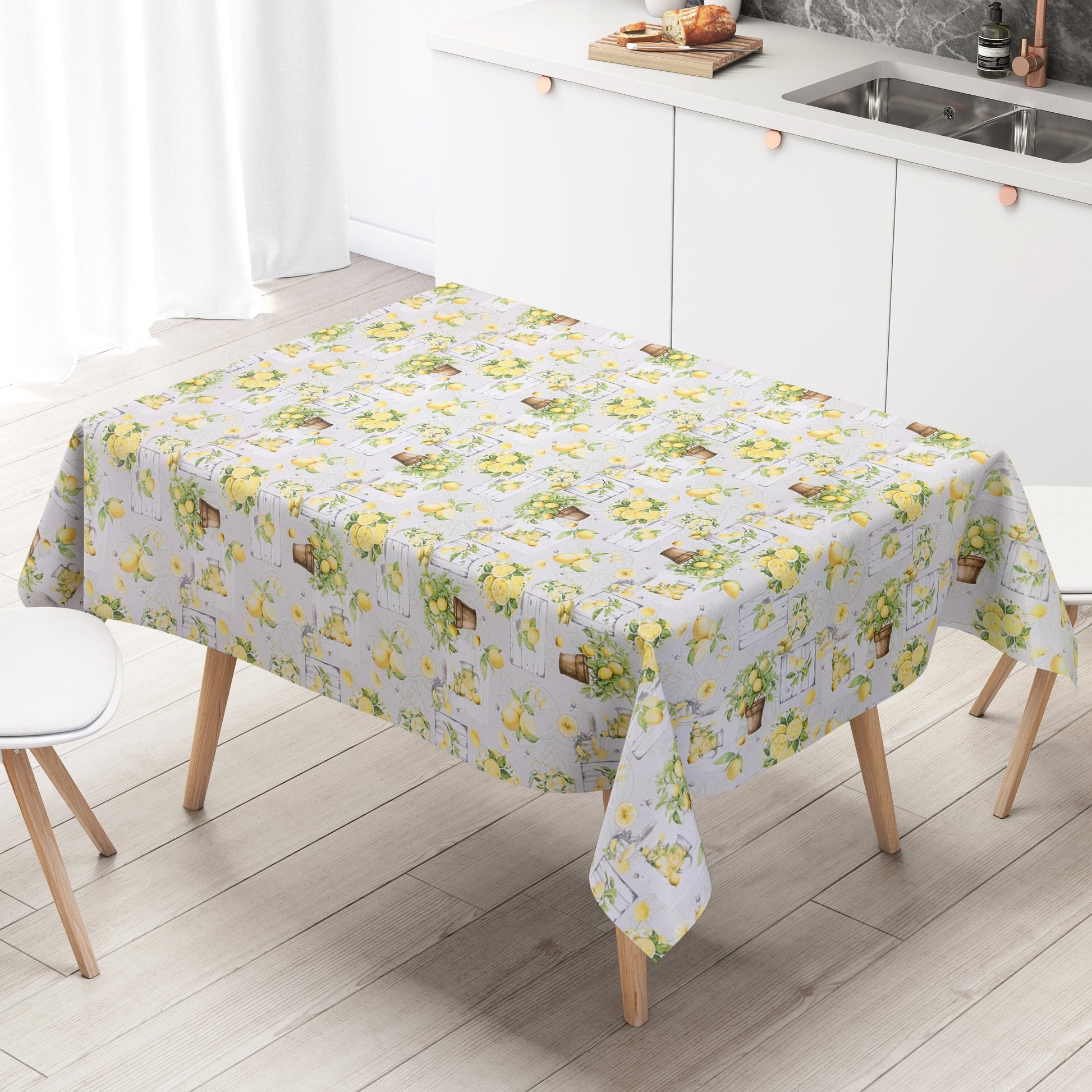 Wachstuch-Tischdecke mit mediterranem Zitronenmuster in Aquarelloptik. Gelbe Zitronen, grüne Blätter, Zitronenbäumchen in Terrakottatöpfen sowie rustikale Holzelemente und Gläser mit Zitronengetränken auf hellem Hintergrund