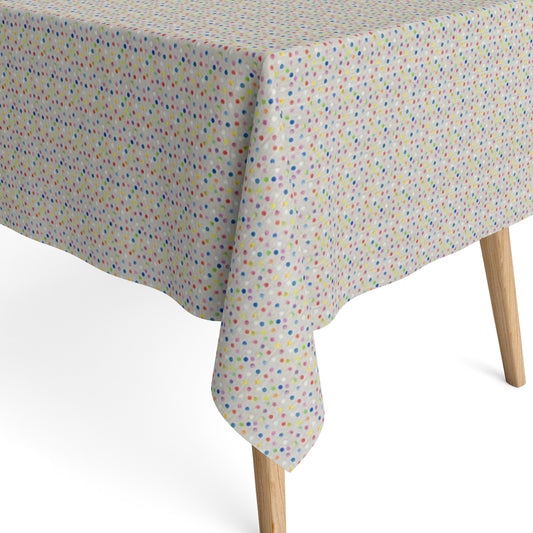 Jacquard-Tischdecke aus beschichteter Baumwolle mit hellem Grund und feinem, buntem Punktmuster in Blau, Rosa, Rot, Gelb, Grün, Orange und Violett.