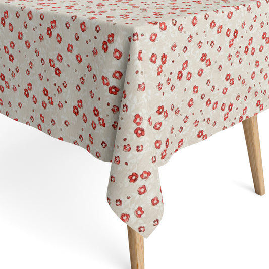 Die Jacquard Tischdecke aus beschichteter Baumwolle zeigt ein feines Streublumenmuster mit kleinen roten Blüten auf hellem, leicht strukturiertem Hintergrund.
