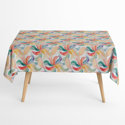 Die Jacquard Tischdecke aus beschichteter Baumwolle zeigt ein modernes, fließendes Muster aus geschwungenen Blattformen in sanften Pastellfarben wie Grün, Blau, Gelb und Rot.